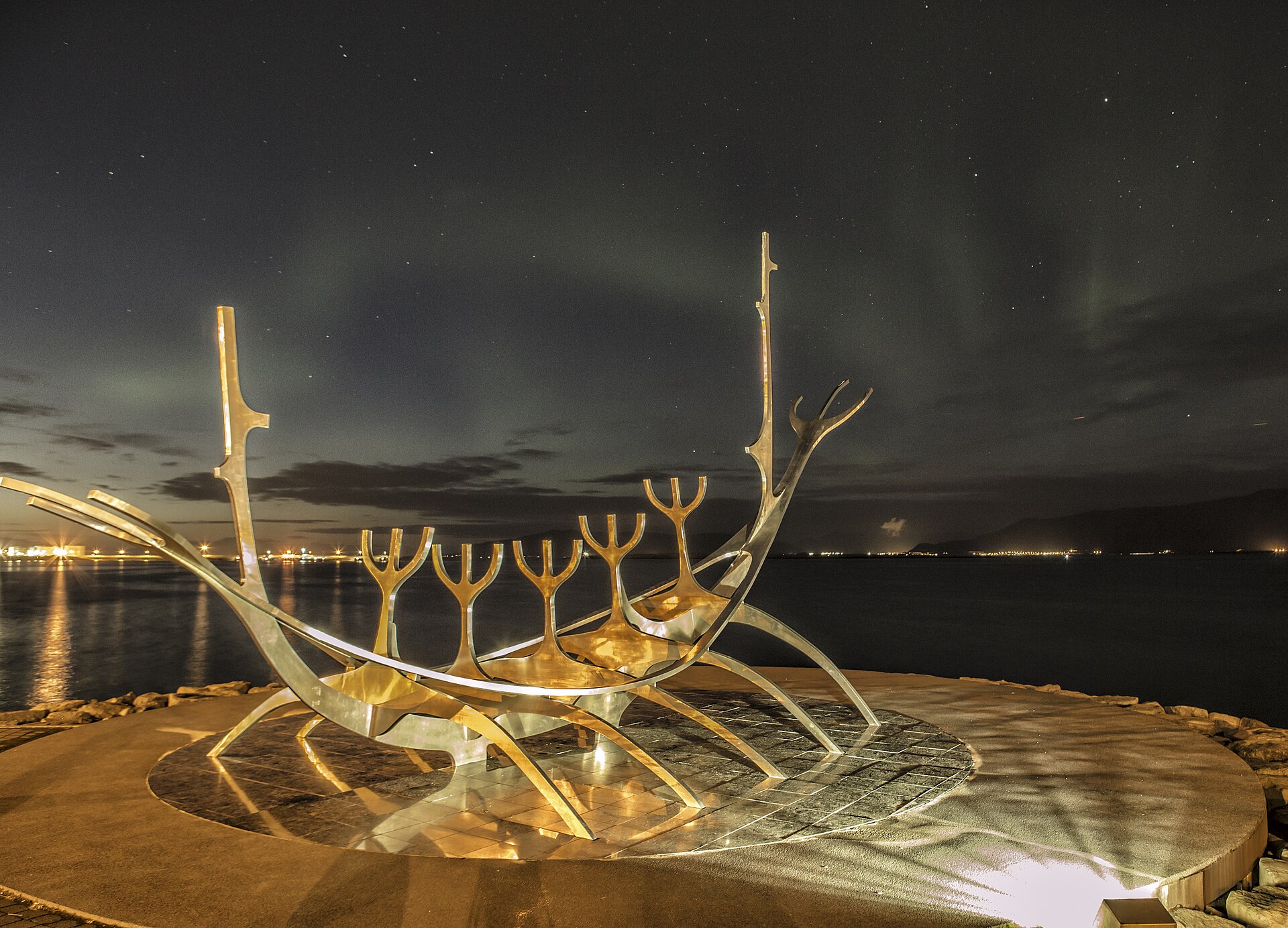 The Sun Voyager sculpture on the Reykjavik shoreline under the northern lights