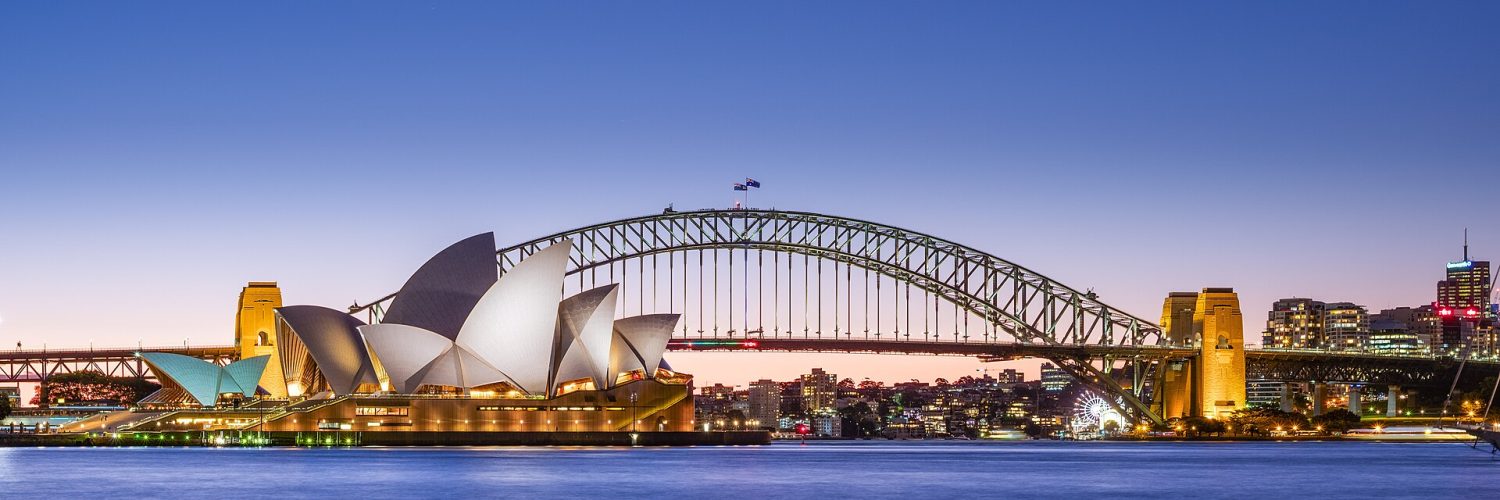 Sydney Opera House and Harbour Bridge at dusk seen across the harbour