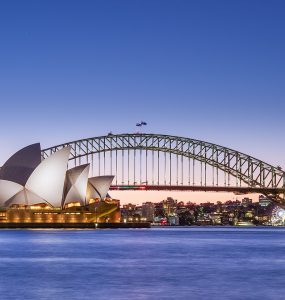 Sydney Opera House and Harbour Bridge at dusk seen across the harbour