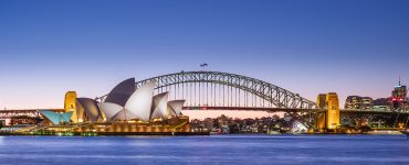 Sydney Opera House and Harbour Bridge at dusk seen across the harbour