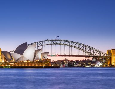 Sydney Opera House and Harbour Bridge at dusk seen across the harbour