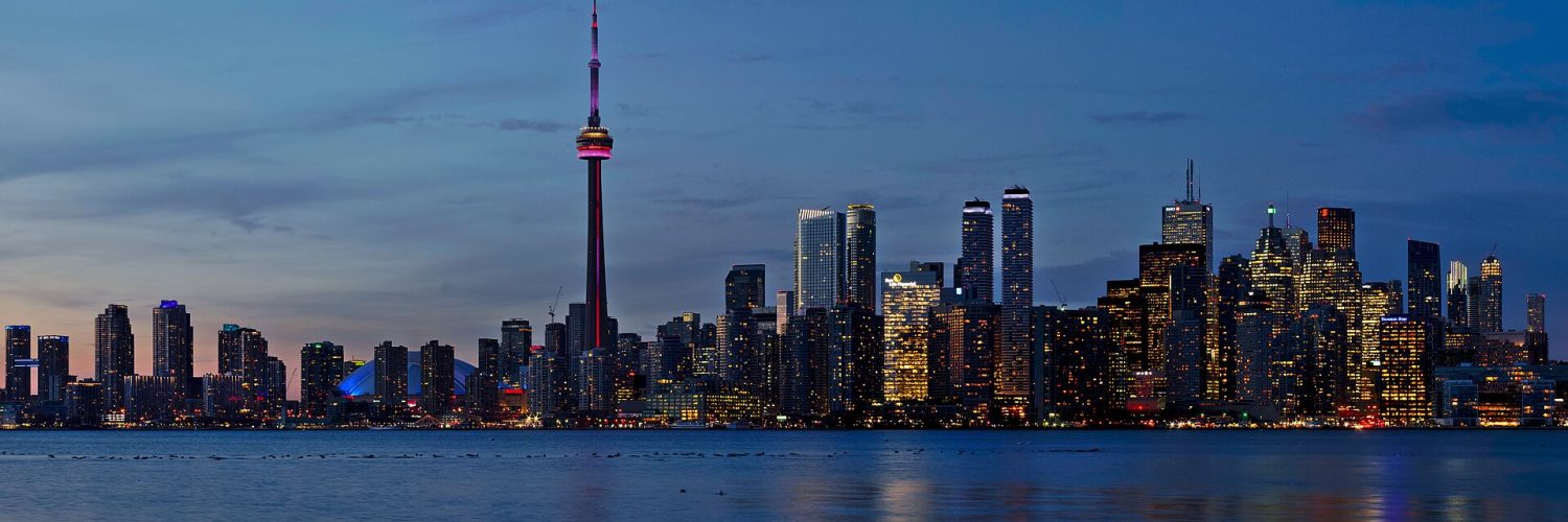Toronto skyline at sunset seen across Lake Ontario