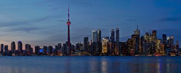 Toronto skyline at sunset seen across Lake Ontario
