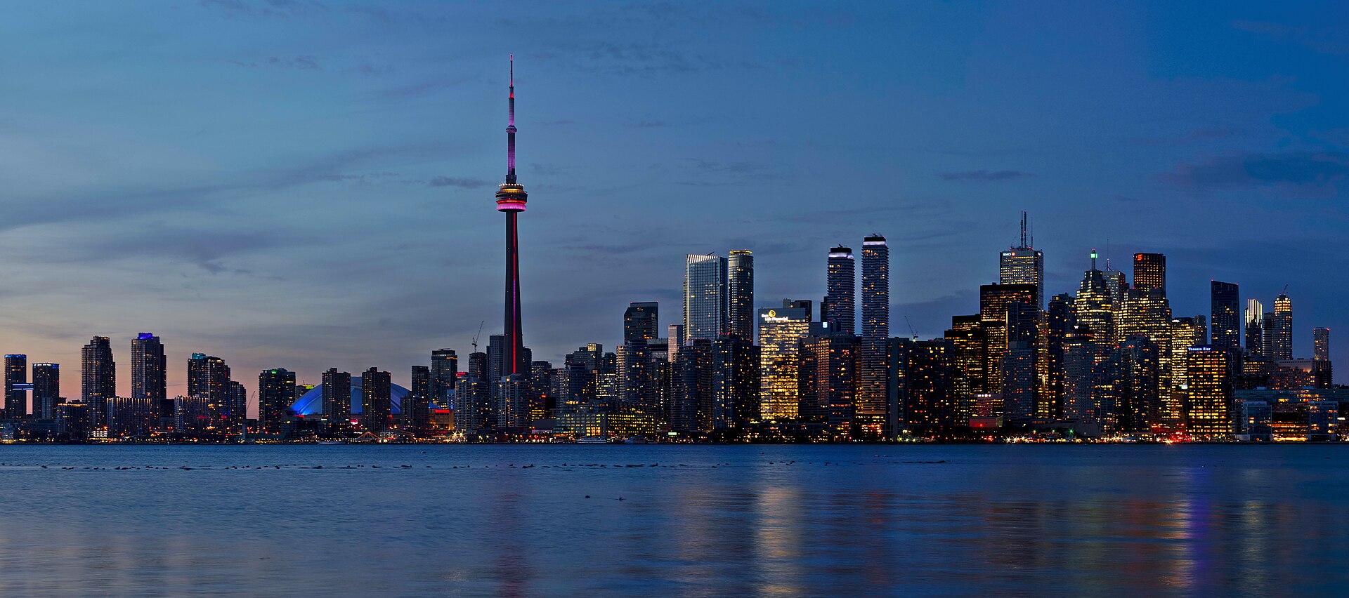 Toronto skyline at sunset seen across Lake Ontario