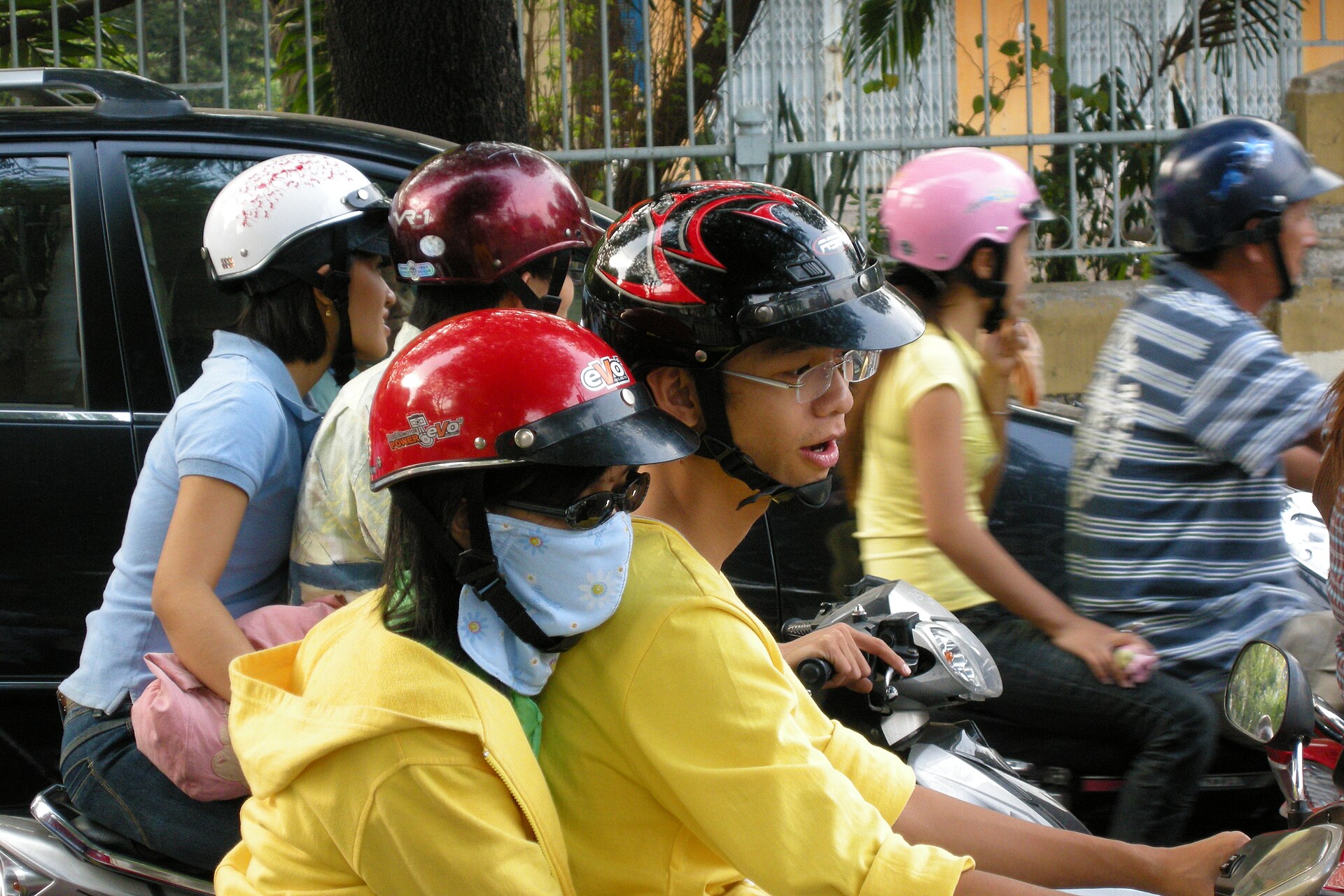 Dense scooter traffic on a street in Ho Chi Minh City