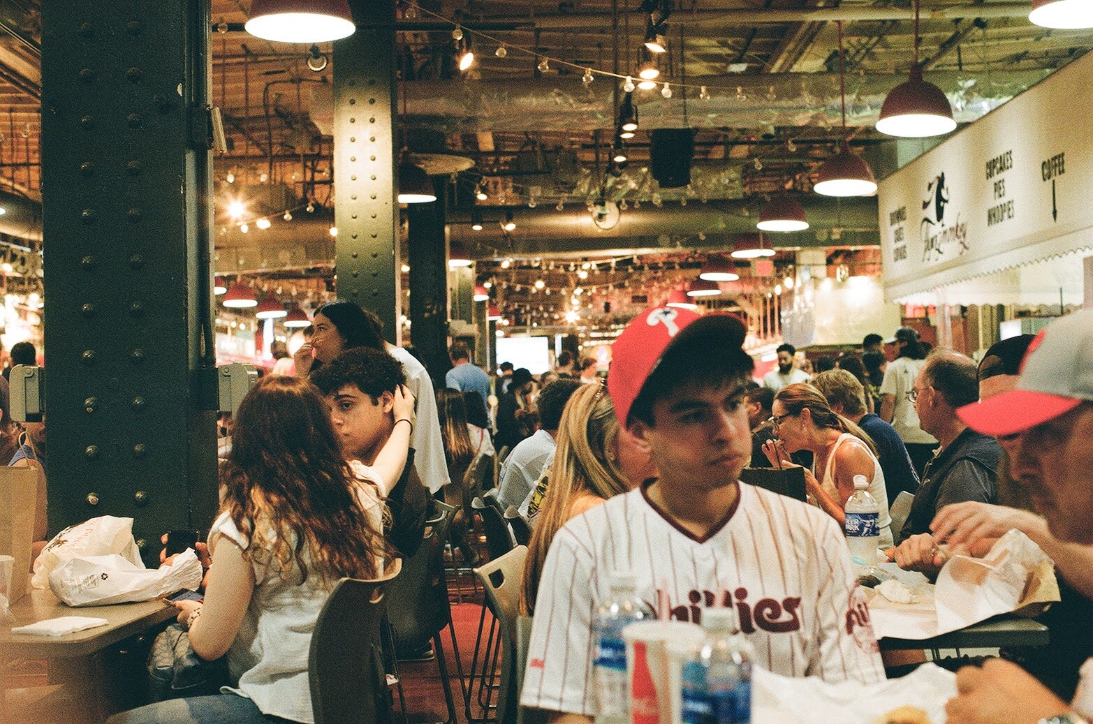 Food stalls and shoppers inside Reading Terminal Market in Philadelphia