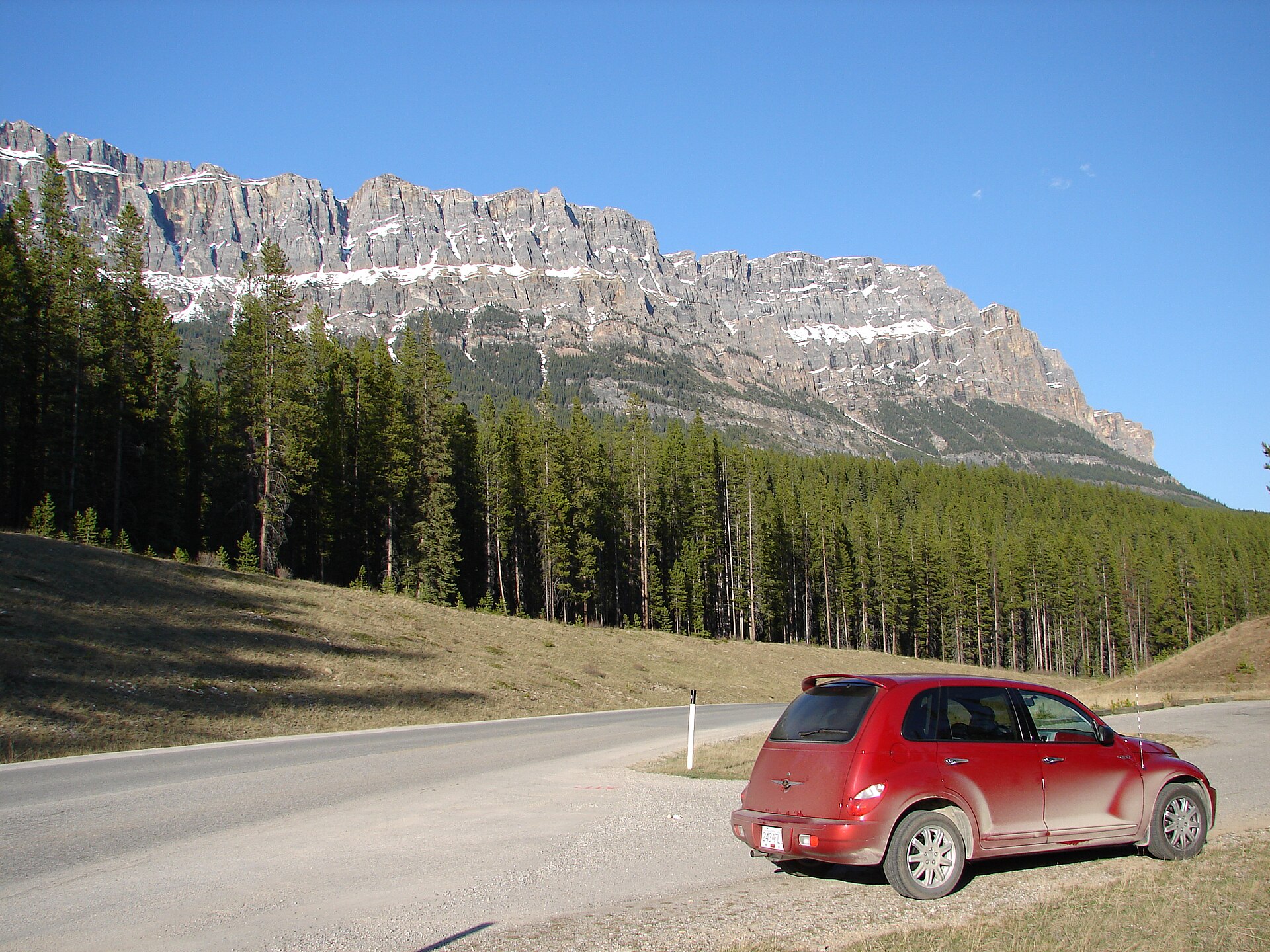 The quiet two lane Bow Valley Parkway winding through forest in Banff National Park