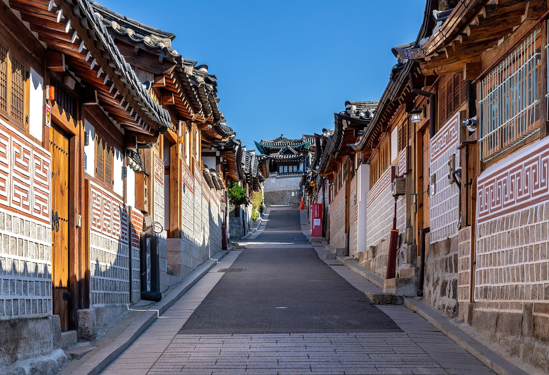 Sloping lane of tiled-roof hanok houses on Bukchon-ro 11-gil in Bukchon Hanok Village, Seoul