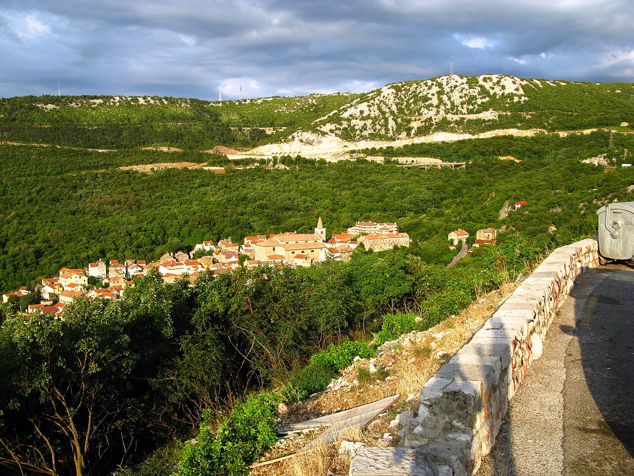 Winding coastal road above a blue Adriatic bay on the Croatian coast