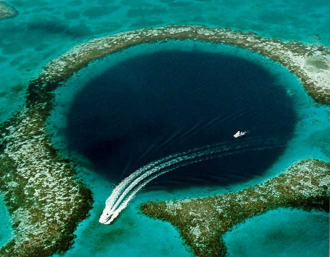 The circular Great Blue Hole sinkhole in the Belize Barrier Reef seen from the air