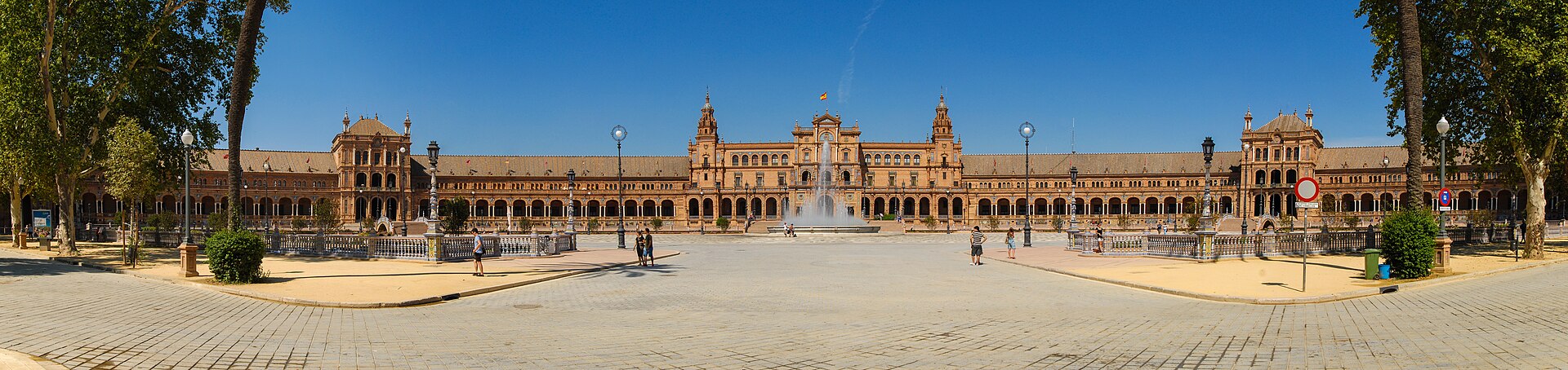 The curved brick facade and canal of the Plaza de Espana in Seville