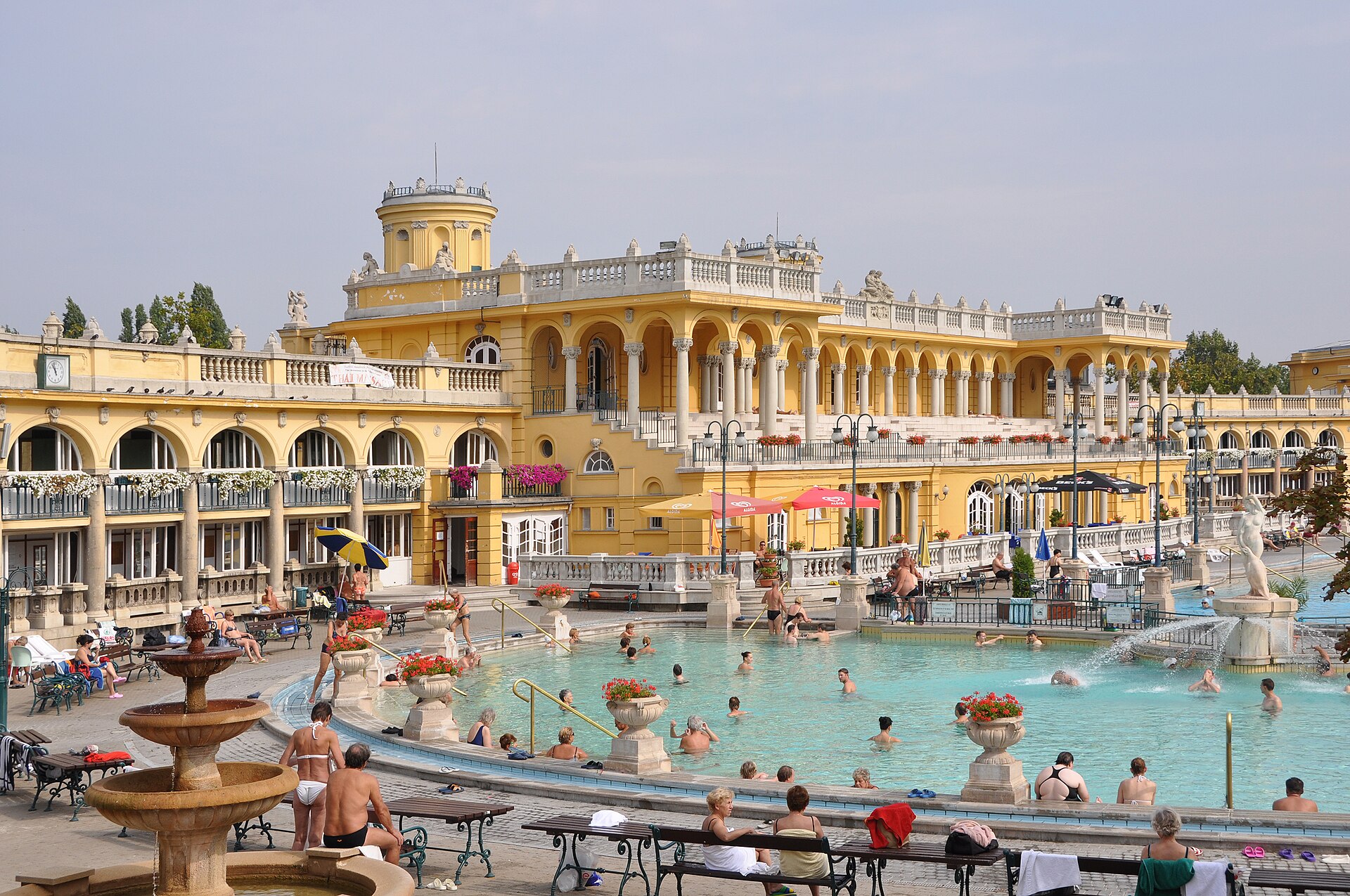 Outdoor pools and yellow neo-baroque facades at the Szechenyi thermal bath complex in Budapest