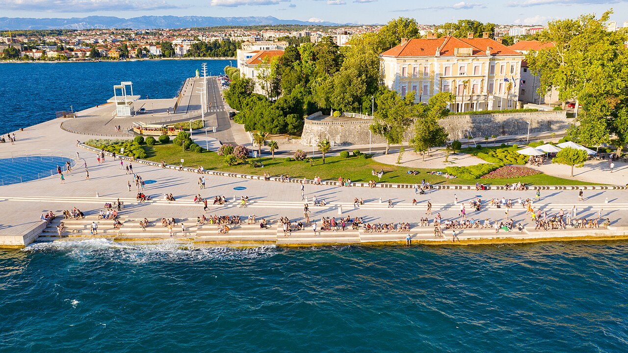 The Sea Organ steps on the Zadar waterfront with visitors sitting above the Adriatic
